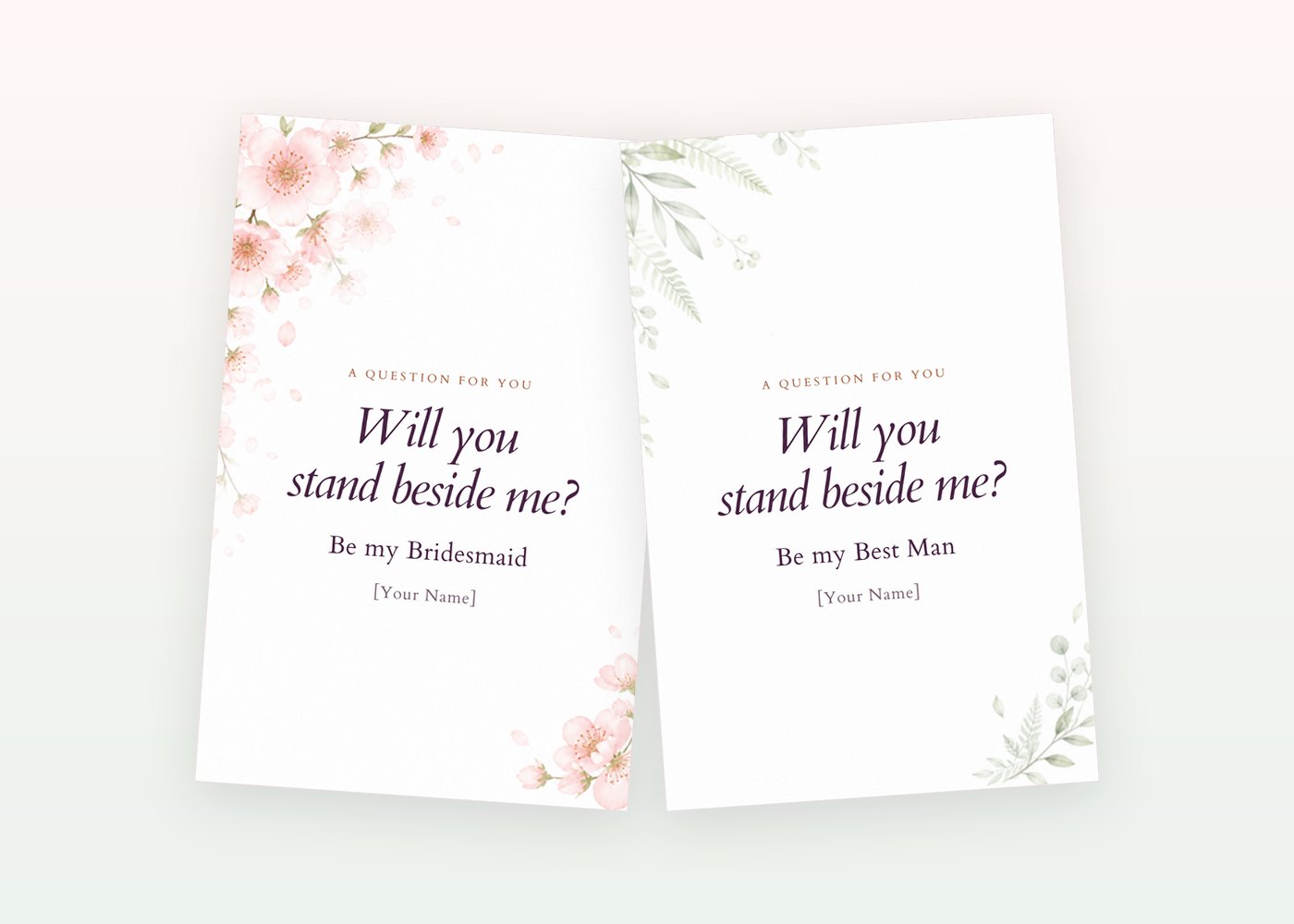 Two card styles side by side: pink blossoms on the Bridesmaid card and soft sage greenery on the Best Man card