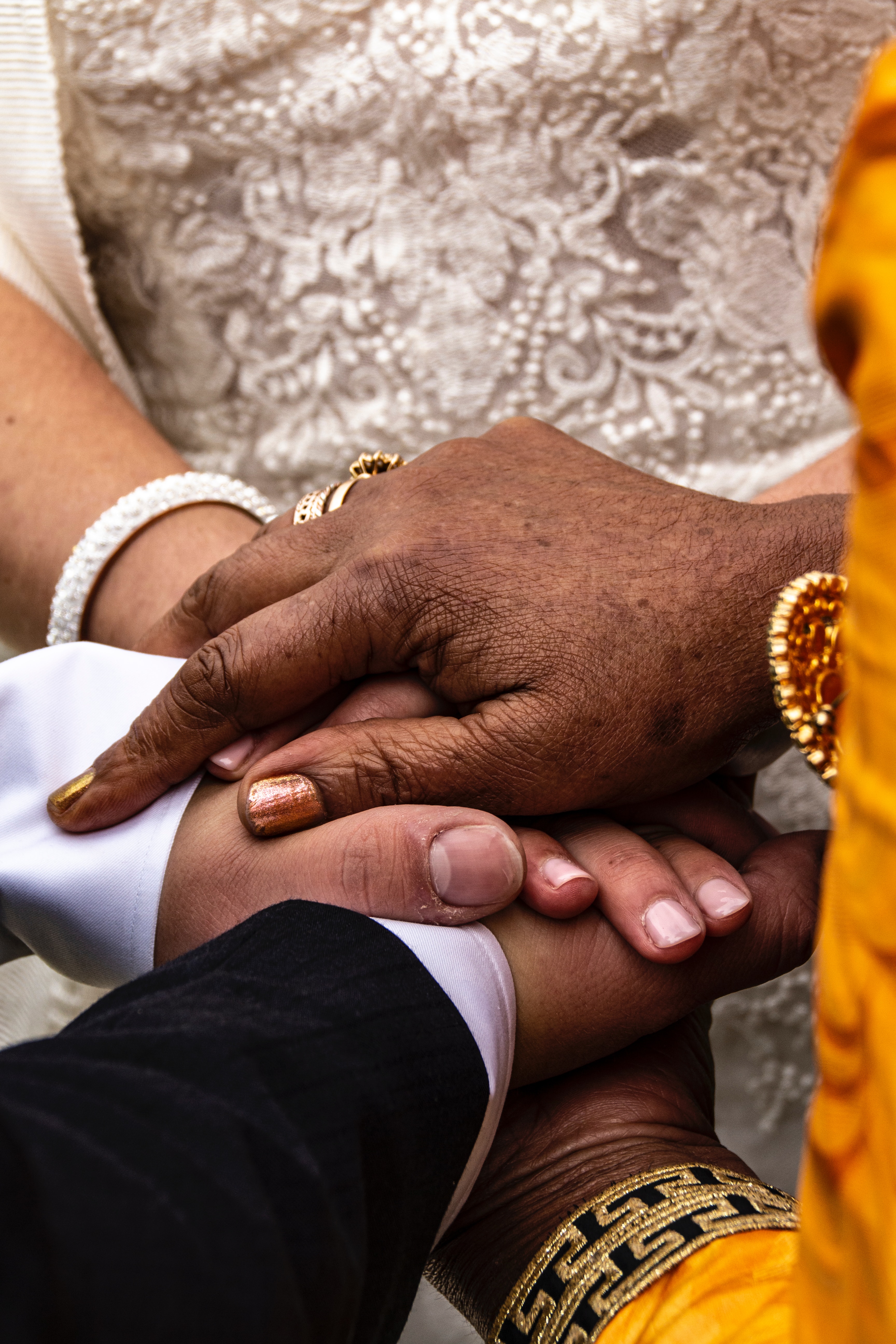 Close-up of couple holding hands during the pronouncement of marriage in a wedding ceremony