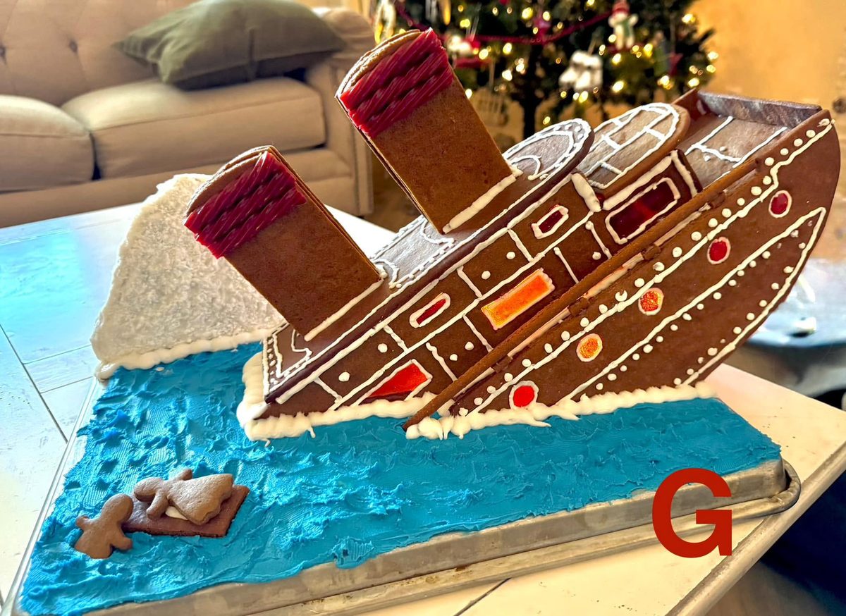 A family gingerbread contest entry: the Titanic sinking beside an icing iceberg in blue frosting water, with gingerbread Rose on a door and Jack in the water beside her